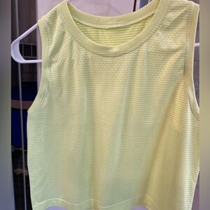 Size 4 lululemon cropped swiftly tech boxy tank in neon yellow. Says LULULEMON